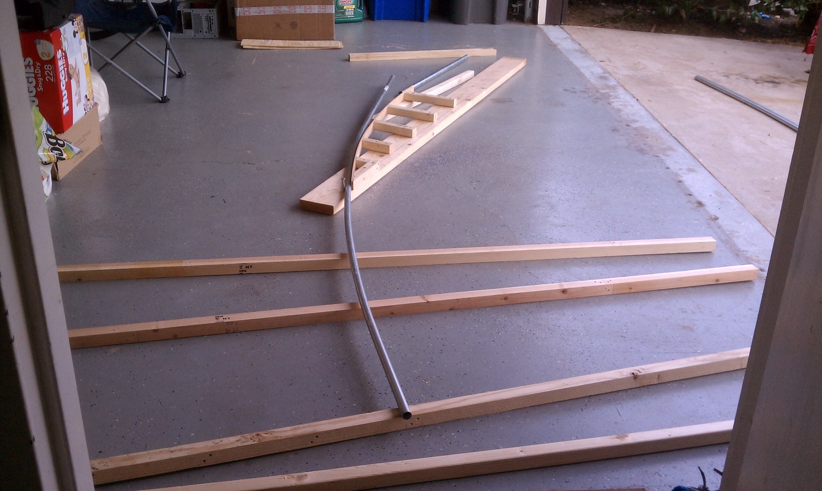 Close view of the wooden jig showing the stepped blocks that set the curve.