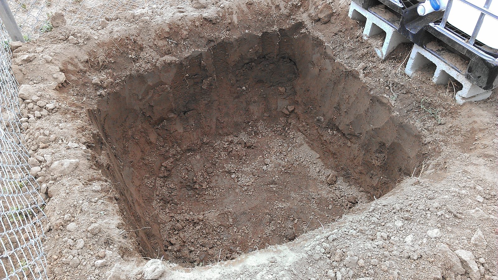 The excavation squared up with clean vertical walls, ready for block.
